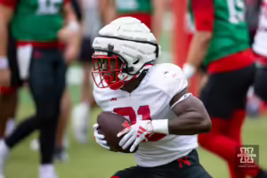 Nebraska Cornhusker Emmett Johnson (21) runs with the ball during football practice Friday, August 9, 2024, in Lincoln, Nebraska. Photo John S. Peterson.