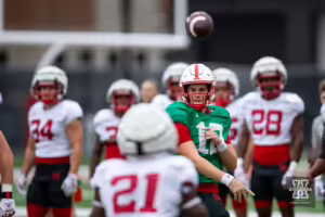 Nebraska Cornhusker Daniel Kaelin (12) throws a pass to DUPLICATE***Nebraska Cornhusker Emmett Johnson (21) during football practice Friday, August 9, 2024, in Lincoln, Nebraska. Photo John S. Peterson.