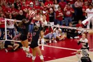 Nebraska Cornhusker Merritt Beason (13) spikes the ball against Stanford Cardinal Elia Rubin (13) and Sami Francis in the first set during a college volleyball match Wednesday, September 18, 2024, in Lincoln, Nebraska. Photo by John S. Peterson.