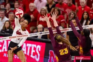 Nebraska Cornhusker Harper Murray (27) spikes the ball against Arizona State Sundevil middle blocker Claire Jeter (23) and Shania Cromartie the first set during the college volleyball match Friday, September 13, 2024, in Lincoln, Nebraska. Photo John S. Peterson.