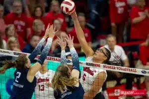 Nebraska Cornhusker Rebekah Allick (5) spikes the all against Creighton Bluejay Norah Sis (2) and Elise Goetzinger (13) during the college volleyball match Tuesday, September 10, 2024, in Lincoln, Nebraska. Photo John S. Peterson.