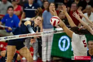 Creighton Bluejay outside hitter Norah Sis (2) spikes the ball against Nebraska Cornhusker middle blocker Rebekah Allick (5) in the fourth set during the college volleyball match Tuesday, September 10, 2024, in Lincoln, Nebraska. Photo John S. Peterson.