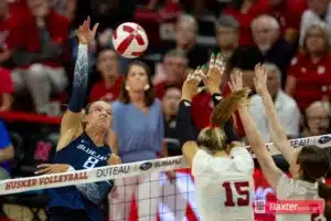 Nebraska Cornhusker libero/defensive specialist Lexi Rodriguez (8) spikes the ball against Nebraska Cornhusker middle blocker Andi Jackson (15) and setter Bergen Reilly (2) in the fourth set during the college volleyball match Tuesday, September 10, 2024, in Lincoln, Nebraska. Photo John S. Peterson.