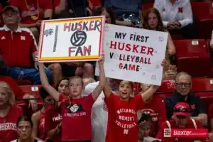 Nebraska Cornhusker fans holding up signs against the Creighton Bluejays during the college volleyball match Tuesday, September 10, 2024, in Lincoln, Nebraska. Photo John S. Peterson.