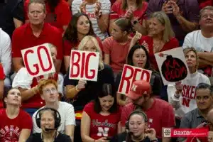 Nebraska Cornhusker fans holding a Go Big Red signs against the Creighton Bluejays during the college volleyball match Tuesday, September 10, 2024, in Lincoln, Nebraska. Photo John S. Peterson.