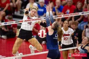 Nebraska Cornhusker middle blocker Andi Jackson (15) spikes the ball past Creighton Bluejay setter Kendra Wait (15) in the second set during the college volleyball match Tuesday, September 10, 2024, in Lincoln, Nebraska. Photo John S. Peterson.