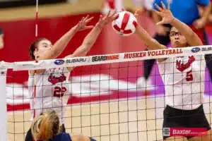 Nebraska Cornhusker Lindsay Krause (22) and Rebekah Allick block a shot from Creighton Bluejay outside hitter Ava Martin (8) in the second set during the college volleyball match Tuesday, September 10, 2024, in Lincoln, Nebraska. Photo John S. Peterson.