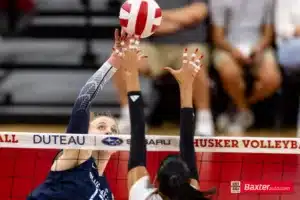 Creighton Bluejay defensive specialist Morgan Colangelo (13) taps the ball against Nebraska Cornhusker outside hitter Harper Murray (27) in the second set during the college volleyball match Tuesday, September 10, 2024, in Lincoln, Nebraska. Photo John S. Peterson.