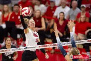 Nebraska Cornhusker middle blocker Andi Jackson (15) spikes the ball against Creighton Bluejay middle blocker Kiara Reinhardt (5) in the first set during the college volleyball match Tuesday, September 10, 2024, in Lincoln, Nebraska. Photo John S. Peterson.