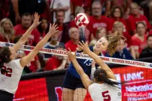 Creighton Bluejay defensive specialist Morgan Colangelo (13) spikes the ball against Nebraska Cornhusker outside hitter Lindsay Krause (22) and middle blocker Rebekah Allick (5) in the first set during the college volleyball match Tuesday, September 10, 2024, in Lincoln, Nebraska. Photo John S. Peterson.