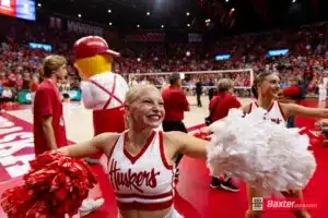 Nebraska Cornhusker cheer squad member leading in cheers against the Creighton Bluejays during the college volleyball match Tuesday, September 10, 2024, in Lincoln, Nebraska. Photo John S. Peterson.