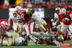 Nebraska Cornhusker running back Rahmir Johnson (14) tackled by Colorado Buffalo linebacker Nikhai Hill-Green (41) and Cam'Ron Silmon-Craig (7) during the college football game Saturday, September 7, 2024, in Lincoln, Nebraska. Photo John S. Peterson.