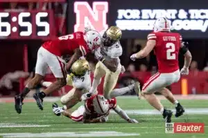 Nebraska Cornhusker defensive back Tommi Hill (6) and Malcolm Hartzog Jr.(7) tackles Colorado Buffalo running back Dallan Hayden (7) during the college football game Saturday, September 7, 2024, in Lincoln, Nebraska. Photo John S. Peterson.