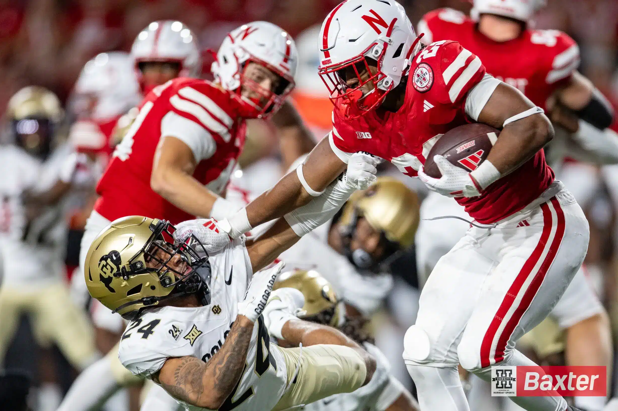 Nebraska Cornhusker running back Dante Dowdell (23) stiff arms Colorado Buffalo cornerback Preston Hodge (24) in the third quarter during the college football game Saturday, September 7, 2024, in Lincoln, Nebraska. Photo John S. Peterson.