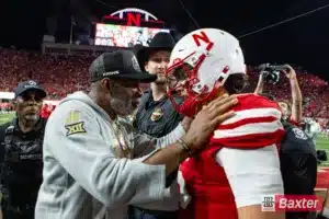 Nebraska Cornhusker quarterback Dylan Raiola (15) and Colorado Buffalo head coach Deion Sanders hug and talk after the college football game Saturday, September 7, 2024, in Lincoln, Nebraska. Photo John S. Peterson.