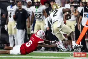 Nebraska Cornhusker defensive back Tommi Hill (6) trips up Colorado Buffalo quarterback Shedeur Sanders (2) in the second quarter during the college football game Saturday, September 7, 2024, in Lincoln, Nebraska. Photo John S. Peterson.