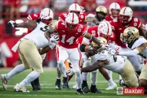 Nebraska Cornhusker running back Rahmir Johnson (14) runs the ball against Colorado Buffalo linebacker LaVonta Bentley (20) breaking a tackle in the first quarter during the college football game Saturday, September 7, 2024, in Lincoln, Nebraska. Photo John S. Peterson.