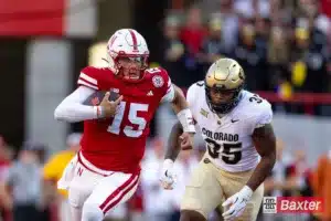 Nebraska Cornhusker quarterback Dylan Raiola (15) runs with the ball against Colorado Buffalo defensive end BJ Green II (35) during the college football game Saturday, September 7, 2024, in Lincoln, Nebraska. Photo John S. Peterson.