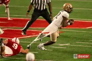Colorado Buffaloes quarterback Shedeur Sanders (2) slips the grip of Nebraska Cornhuskers defensive lineman Ty Robinson (9) during a game against the Colorado Buffaloes Saturday, September 7th 2024 at Memorial Stadium in Lincoln, Nebraska. Nebraska Photo by Eric Francis