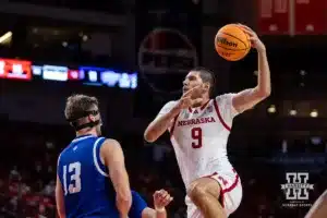 Nebraska Cornhusker Berke Büyüktuncel (9) goes for a layup against Grand Valley State Laker Ethan Alderink (13) in the first half during a college men’s basketball game Thursday, October 27, 2024, in Lincoln, Nebraska. Photo by John S. Peterson.