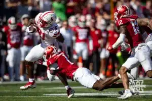 Nebraska Cornhusker running back Emmett Johnson (21) runs with the ball against Indiana Hoosier defensive back Shawn Asbury II (1) during a football game Saturday, October 19, 2024, in Bloomington, Indiana. Photo by John S. Peterson.