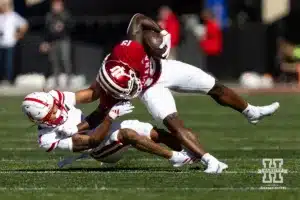 Nebraska Cornhusker defensive back Malcolm Hartzog Jr. (7) tackles Indiana Hoosier wide receiver Miles Cross (19 during a football game Saturday, October 19, 2024, in Bloomington, Indiana. Photo by John S. Peterson.