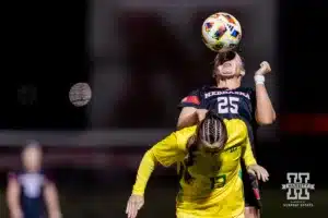 Nebraska Cornhusker midfielder Ella Rudney (25) heads the ball against Oregon Duck forward Ajanae Respass (13) in the second half during a soccer match Thursday, October 17, 2024, in Lincoln, Nebraska. Photo by John S. Peterson.