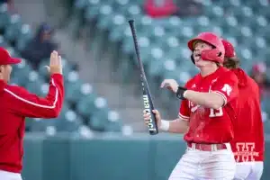 Nebraska's Jaron Cotton (13) celebrates a run during a baseball scrimmage Tuesday, October 15, 2024, in Lincoln, Nebraska. Photo by John S. Peterson.