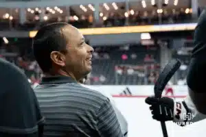 Omaha Maverick equipment manager Jason Smits watches the action on the ice against the Wisconsin Badgers in a college hockey match Saturday, October 5, 2024 in Omaha, Nebraska. Photo by Kyle Byers.