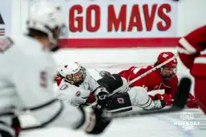 Omaha Maverick Tanner Ludtke (71) slides for the puck against the Wisconsin Badgers in a college hockey match Saturday, October 5, 2024 in Omaha, Nebraska. Photo by Kyle Byers.