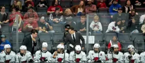 Omaha head coach Mike Gabinet and Assistant Coach Bennett Hambrook talking to players on the bench against the Wisconsin Badgers in a college hockey match Saturday, October 5, 2024 in Omaha, Nebraska. Photo by Kyle Byers.