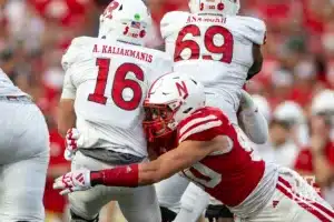 Nebraska Cornhusker defensive lineman James Williams (90) sacks Rutgers Scarlet Knight quarterback Athan Kaliakmanis (16) during a college football game Saturday, October 5, 2024, in Lincoln, Nebraska. Photo by John S. Peterson.