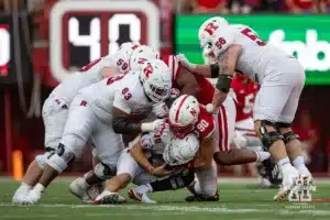 Nebraska Cornhusker defensive lineman James Williams (90) sacks Rutgers Scarlet Knight quarterback Athan Kaliakmanis (16) during a college football game Saturday, October 5, 2024, in Lincoln, Nebraska. Photo by John S. Peterson.