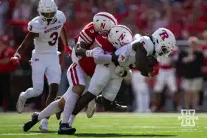 Nebraska Cornhusker linebacker John Bullock (5) and defensive back Marques Buford Jr. (3) tackle Rutgers Scarlet Knight running back Kyle Monangai (5) during a college football game Saturday, October 5, 2024, in Lincoln, Nebraska. Photo by John S. Peterson.