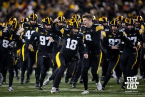 Iowa Hawkeyes place kicker Drew Stevens (18) leads the way to the Hero's Trophy after making a field goal in the last seconds to win the game over the Nebraska Cornhuskers during a college football game Friday, November 29, 2024, in Iowa City, Iowa. Photo by John S. Peterson.
