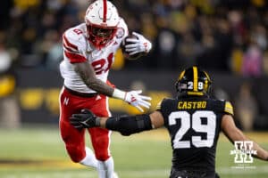 Nebraska Cornhuskers running back Emmett Johnson (21) tries to break a tackle against Iowa Hawkeyes defensive back Sebastian Castro (29) during a college football game Friday, November 29, 2024, in Iowa City, Iowa. Photo by John S. Peterson.