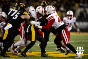 Nebraska Cornhuskers defensive lineman Ty Robinson (9) and linebacker MJ Sherman (48) tackle Iowa Hawkeyes running back Kaleb Johnson (2) during a college football game Friday, November 29, 2024, in Iowa City, Iowa. Photo by John S. Peterson.
