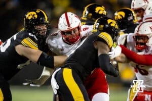 Nebraska Cornhuskers defensive lineman Ty Robinson (9) reaches out to tackle Iowa Hawkeyes running back Kaleb Johnson (2) during a college football game Friday, November 29, 2024, in Iowa City, Iowa. Photo by John S. Peterson.