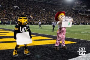 Nebraska Cornhuskers mascot Herbie and Iowa Hawkeyes mascot Herky have fans cheer for the best corn during a college football game Friday, November 29, 2024, in Iowa City, Iowa. Photo by John S. Peterson.