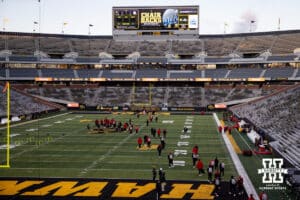 Nebraska Cornhuskers walk out to the center of the field to be confronted by police to keep them off the Hawkeye logo during a college football game against the Iowa Hawkeyes Friday, November 29, 2024, in Iowa City, Iowa. Photo by John S. Peterson.