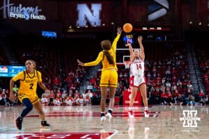 Nebraska Cornhuskers guard Callin Hake (14) makes a three point shot against UMKC Roos guard Emani Bennett (0) in the first quarter during a college women’s basketball game Tuesday, November 26, 2024, in Lincoln, Nebraska. Photo by John S. Peterson.