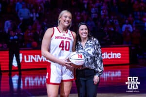 Nebraska Cornhuskers center Alexis Markowski (40) recieves a ball for 1000 career rebounds from head coach Amy Williams before a college women’s basketball game against the UMKC Roos Tuesday, November 26, 2024, in Lincoln, Nebraska. Photo by John S. Peterson.
