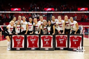 Seniors Merritt Beason (13), Leyla Blackwell (11), Lexi Rodriguez (8), Lindsay Krause (22), and Kennedi Orr (9) pose for a photo with teammates during a college volleyball match Saturday, November 23, 2024 in Lincoln, Nebraska. Photo by John S. Peterson.