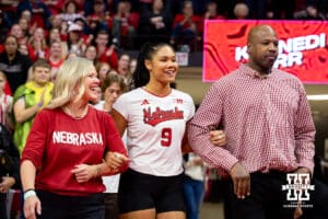 Nebraska Cornhusker setter Kennedi Orr (9) with her parents walking out to be honored on Senior Night after a college volleyball match against the Wisconsin Badgers Saturday, November 23, 2024 in Lincoln, Nebraska. Photo by John S. Peterson.