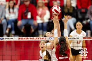 Nebraska Cornhusker setter Bergen Reilly (2) tips the ball against Wisconsin Badger middle blocker CC Crawford (9) in the second set during a college volleyball match Saturday, November 23, 2024 in Lincoln, Nebraska. Photo by John S. Peterson.