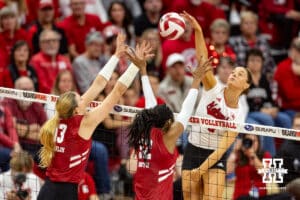 Nebraska Cornhusker Merritt Beason (13) spikes the ball against the Wisconsin Badgers during a college volleyball match Saturday, November 23, 2024 in Lincoln, Nebraska. Photo by John S. Peterson.