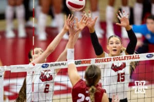 Nebraska Cornhusker setter Bergen Reilly (2) and middle blocker Andi Jackson (15) jump to block Wisconsin Badger libero Julia Orzol (22) during a college volleyball match Saturday, November 23, 2024 in Lincoln, Nebraska. Photo by John S. Peterson.