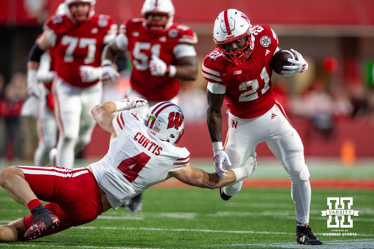 Nebraska Football v Wisconsin November 23, 2024. Nebraska Cornhusker running back Emmett Johnson (21) runs the ball against Wisconsin Badger linebacker Tackett Curtis (4) in the fourth quarter during a college football game Saturday, November 23, 2024 in Lincoln, Nebraska. Photo by John S. Peterson.