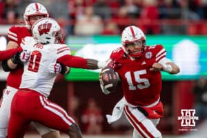 Nebraska Cornhusker quarterback Dylan Raiola (15) scrambles away from Wisconsin Badger linebacker John Pius (0) in the third quarter during a college football game Saturday, November 23, 2024 in Lincoln, Nebraska. Photo by John S. Peterson.
