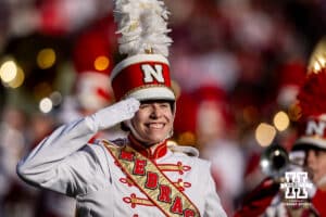 Nebraska Cornhusker Marching Band drum major salutes during the pre-game performance before the college football game against the Wisconsin Badgers Saturday, November 23, 2024 in Lincoln, Nebraska. Photo by John S. Peterson.